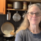 An image of a neatly organized kitchen with labeled containers, shelves, and drawers. There are several kitchen tools and gadgets arranged in an orderly manner, and a few recipe books on the counter. The image represents the topic of kitchen organization blogs.