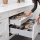 Image not provided. However, the alt text for an image related to tips for organizing kitchen drawers could be: A photo of a kitchen drawer with dividers, utensils, and other kitchen tools neatly arranged.